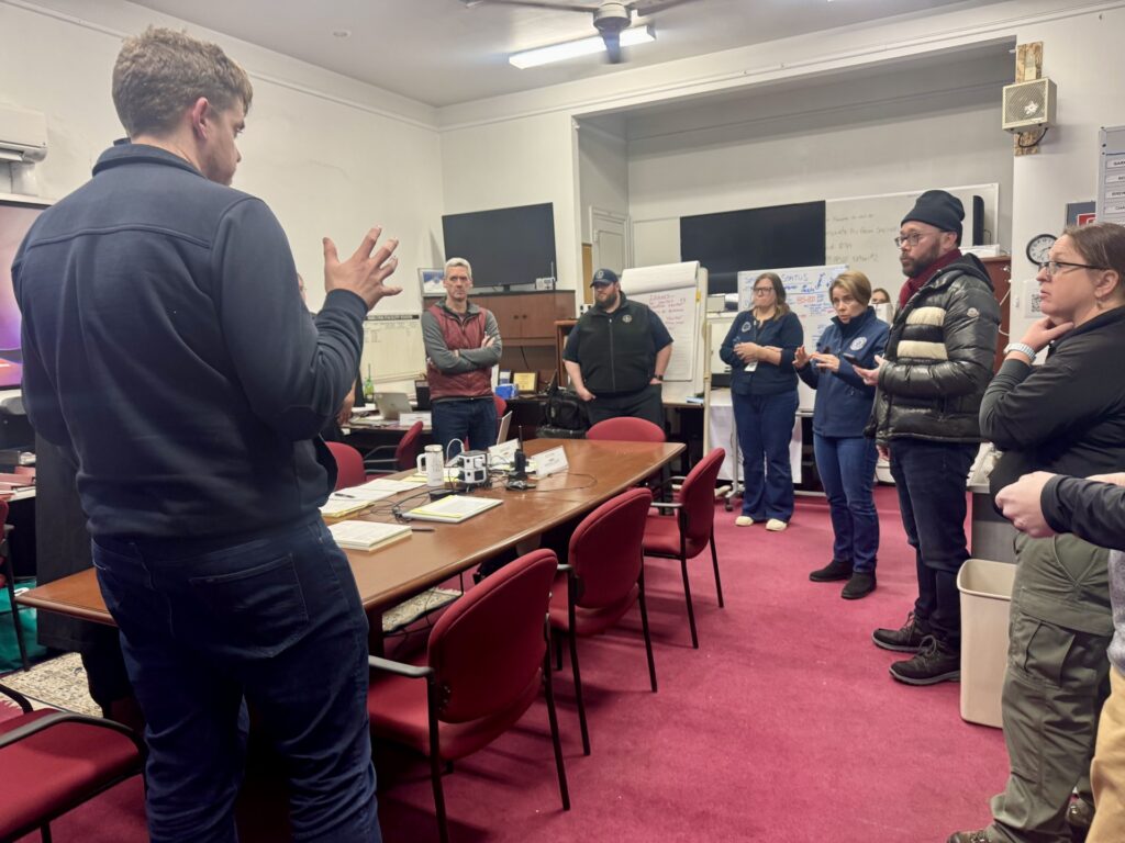 Governor Healey receives a briefing inside the MACC operations room from emergency management leaders, including MACC Manager Mike Walker and Acting Emergency Management Director Andrew Platt.